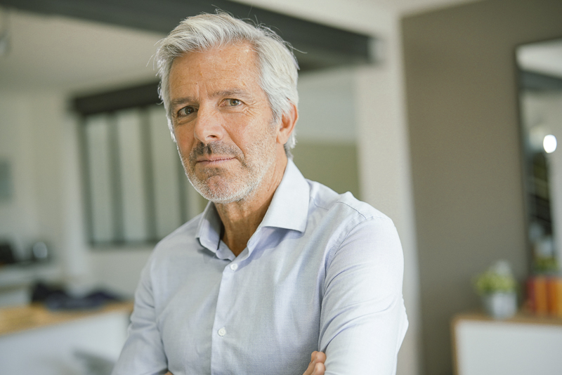 Portrait,Of,Senior,Businessman,With,Arms,Crossed,Looking,At,Camera